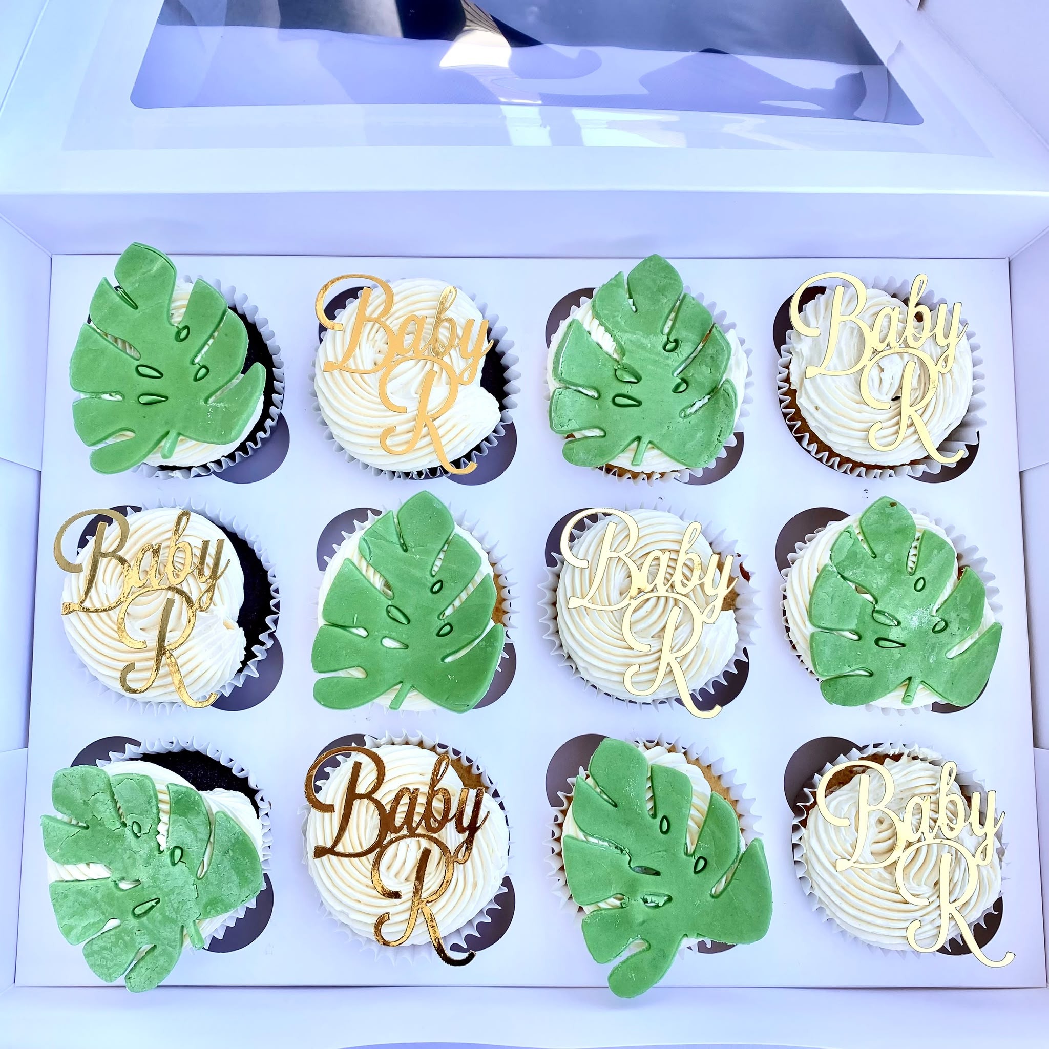 Baby shower cupcakes with monstera leaf toppers