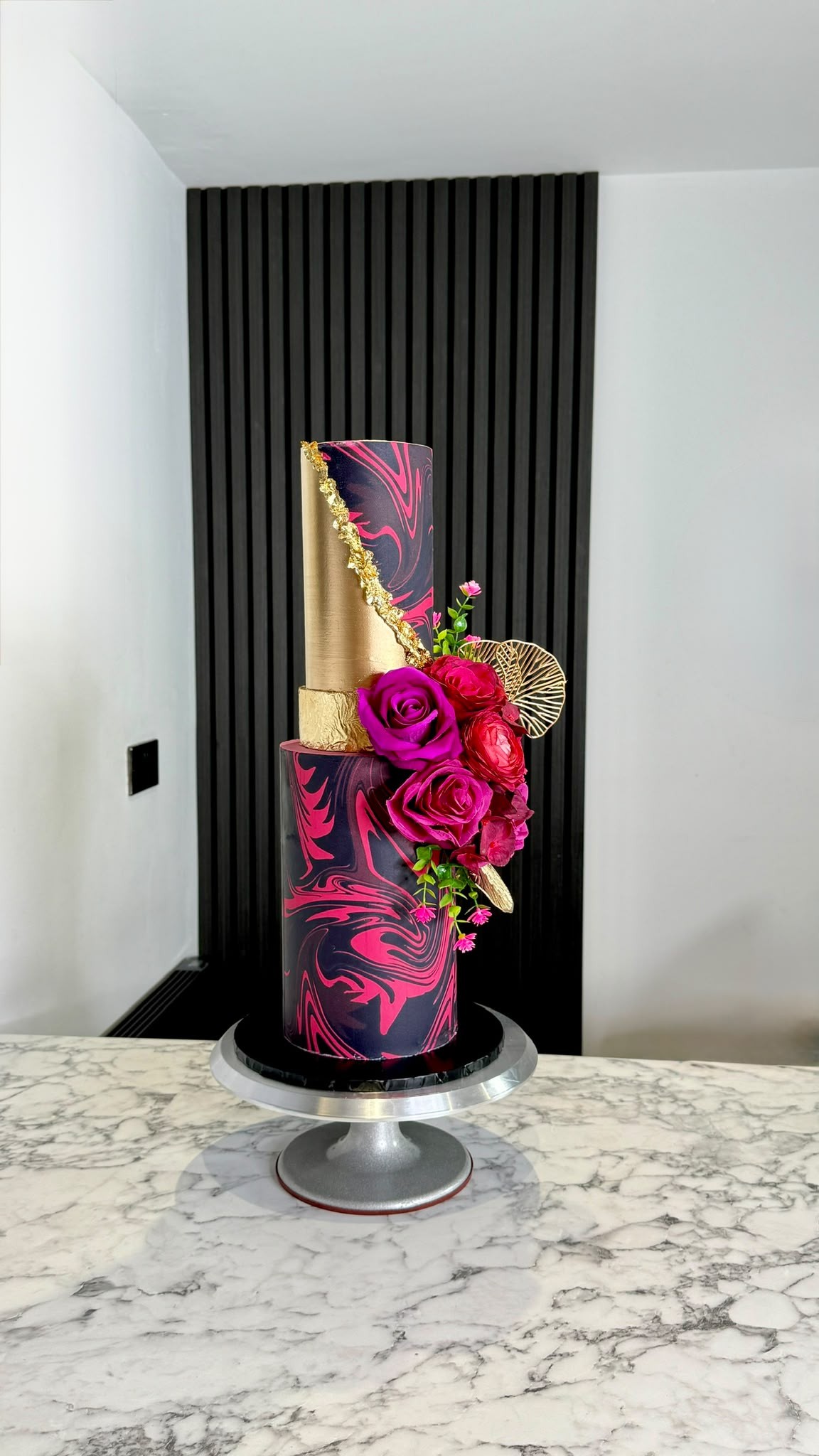 Luxury two-tier black and hot pink marble cake with gold leaf and roses by Lamour Bakes