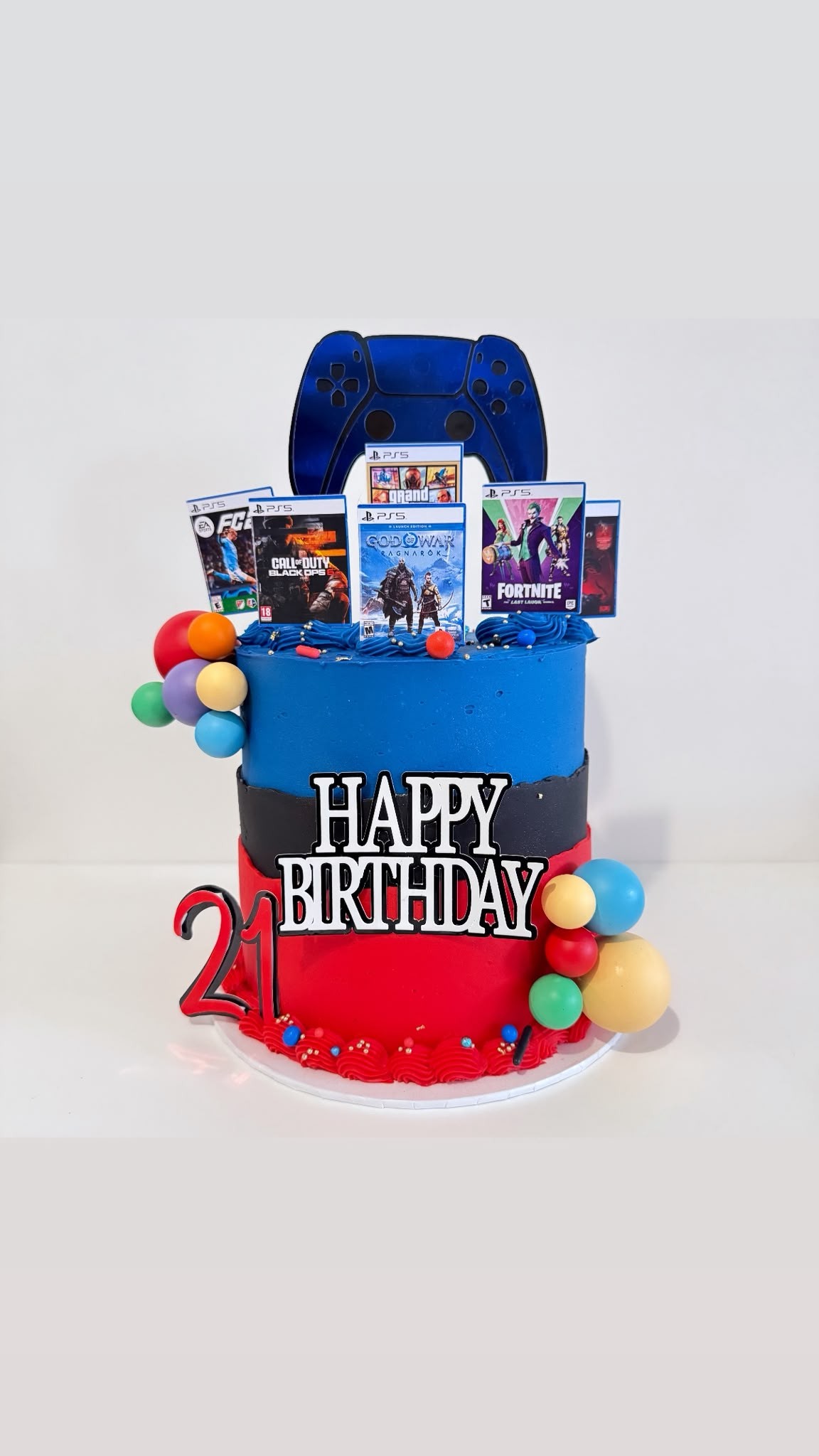 PlayStation gaming themed two-tier birthday cake