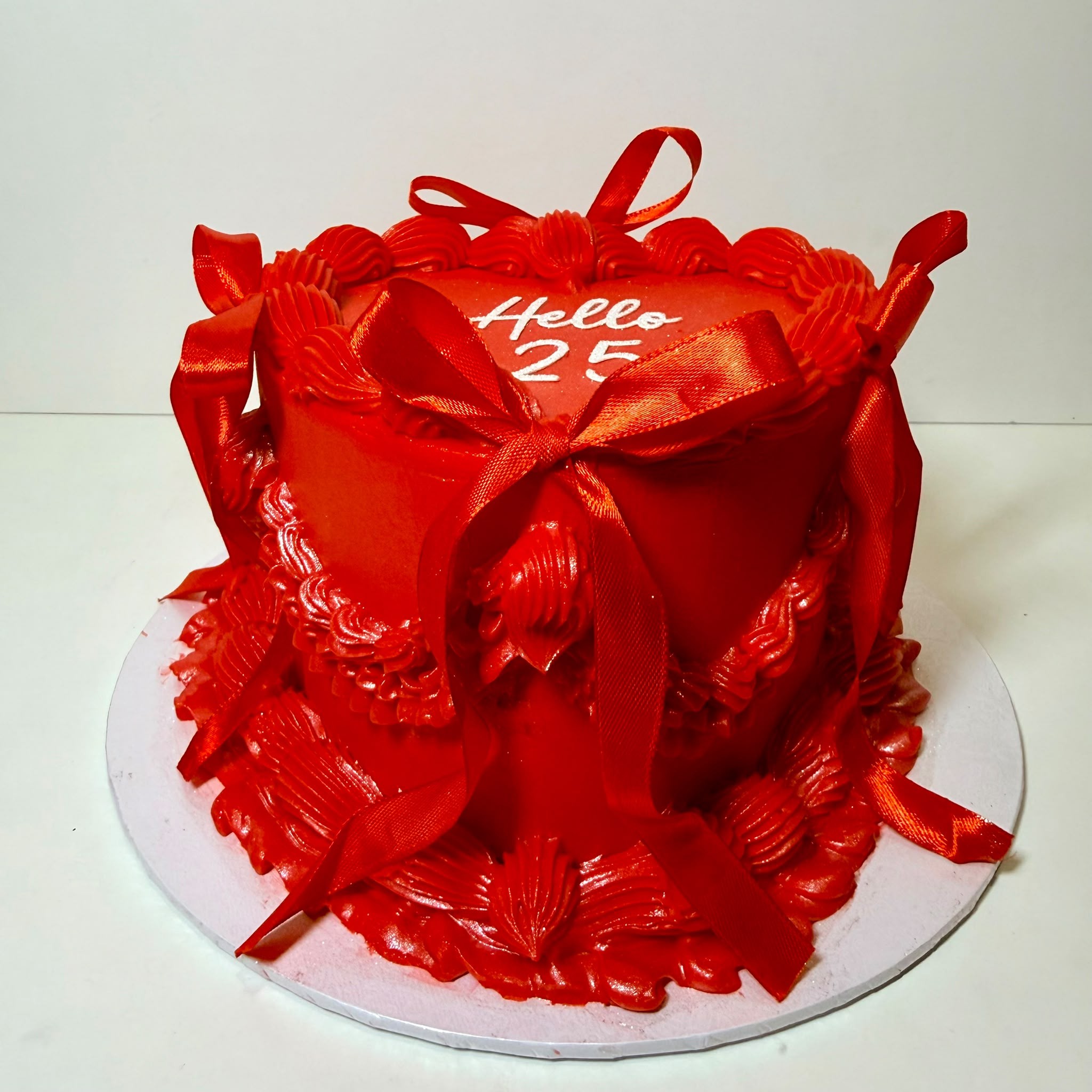 Red vintage Hello 25 birthday cake with ribbon bows